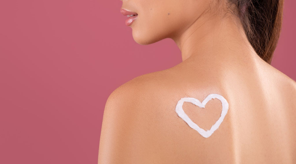 Photo of a heart drawn on the upper back with  moisturizer