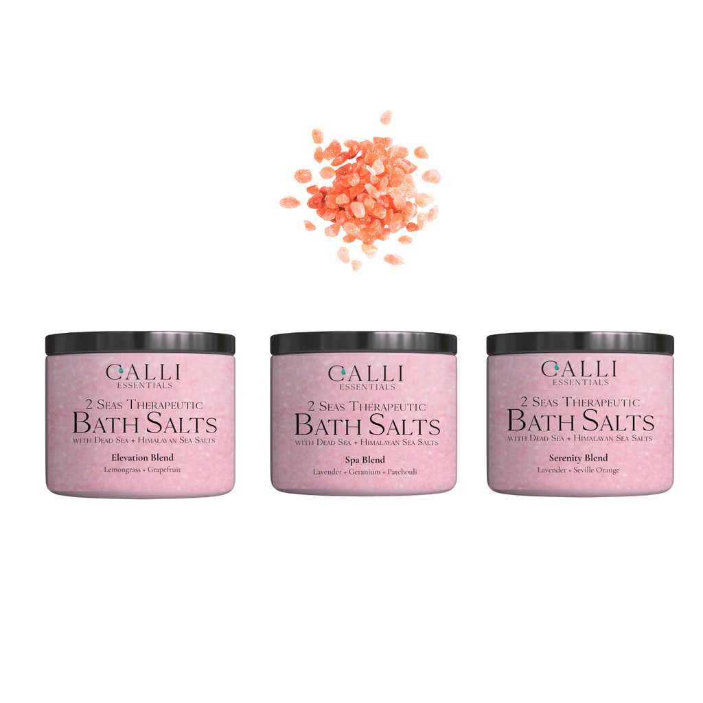 Three jars of Galli Essentials bath salts with a small pile of pink bath salts on a white background.