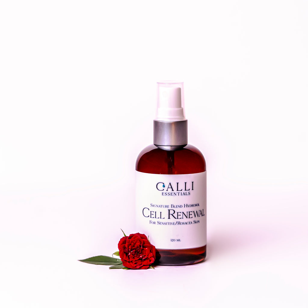Bottle of cell renew hydrosol with a fresh rose beside the bottle