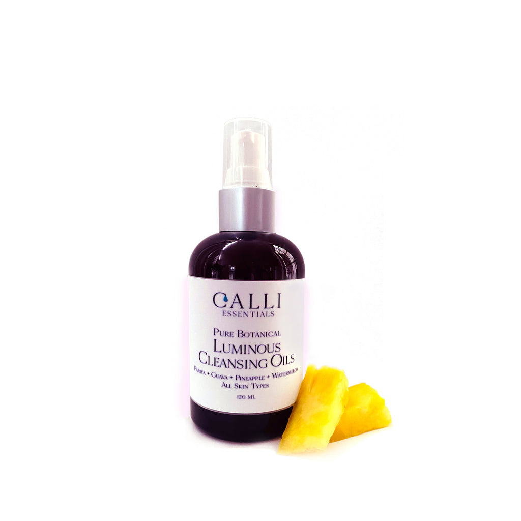luminous cleansing oils with pineapple beside the bottle